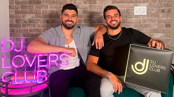Bobby and Bill Hendrickson together in front of the DJ Lovers neon sign