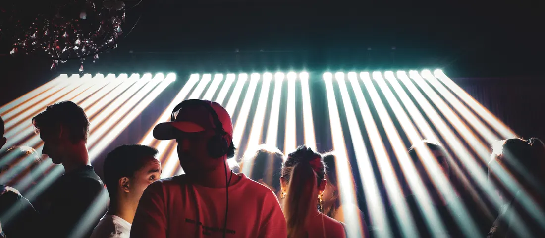 Two friends silhouetted in front of a strobe wall