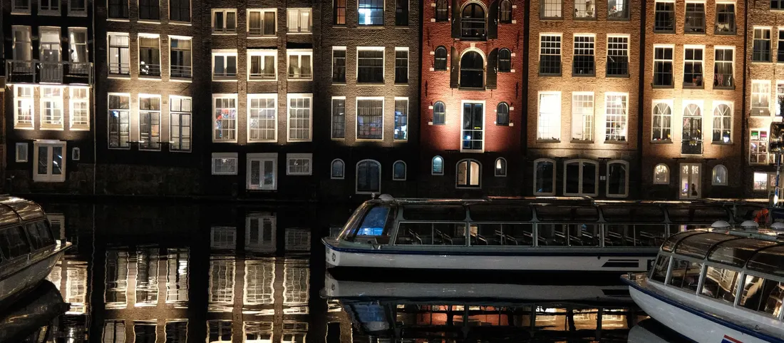 Canal houses at night with lit windows
