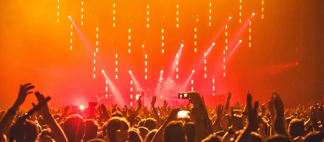 A packed main room under a wall of lights